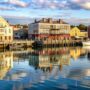 colorful waterfront buildings reflected calm water 90x90