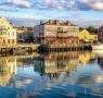 colorful waterfront buildings reflected calm water 95x90