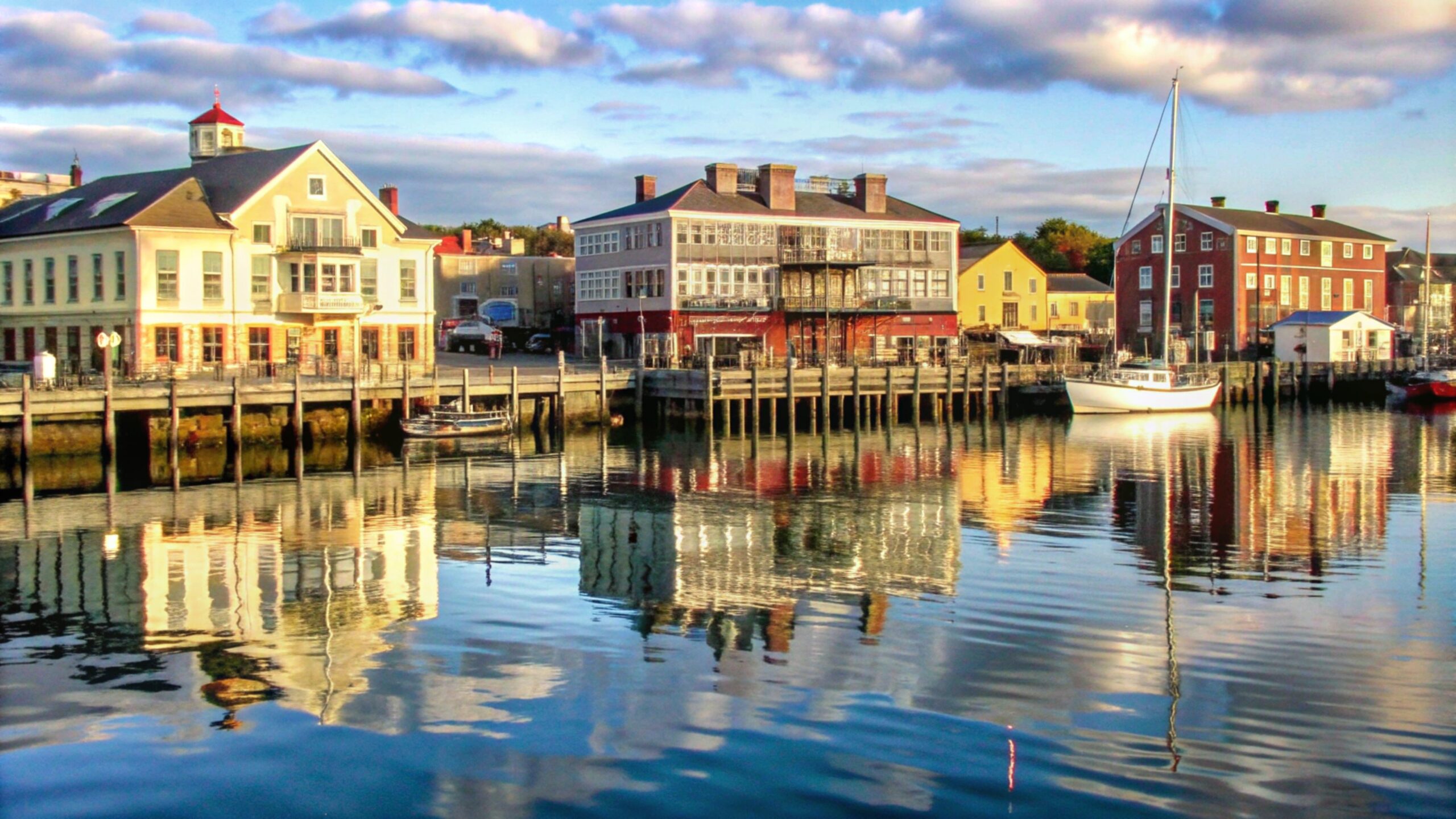 colorful waterfront buildings reflected calm water scaled